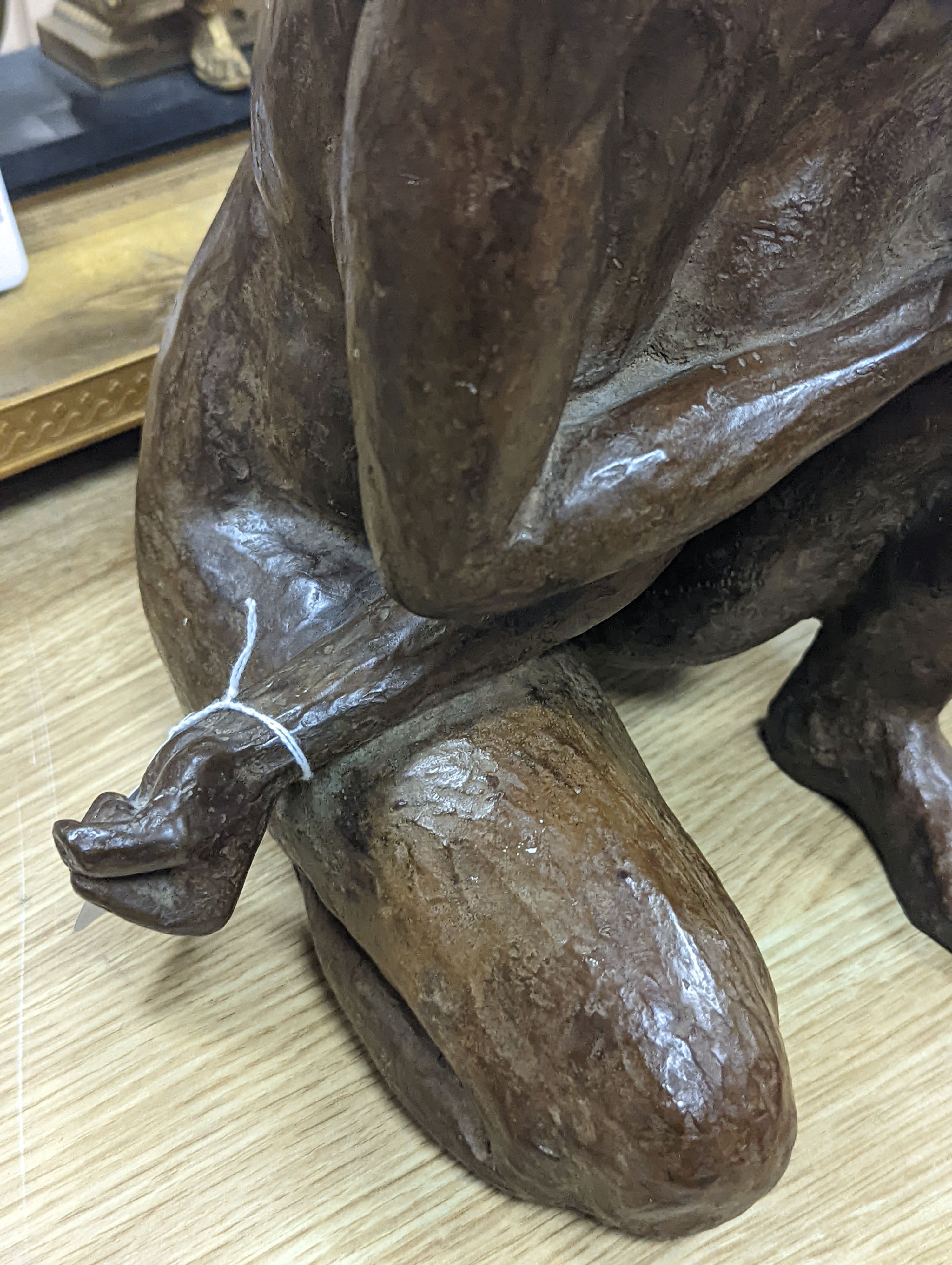 A contemporary bronze of a lady crouching with a thoughtful expression, unsigned - 31cm high